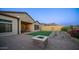 Spacious backyard with covered patio and artificial turf at 8537 E Leland St, Mesa, AZ 85207