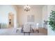 Elegant dining room with a glass table and chandelier at 8537 E Leland St, Mesa, AZ 85207