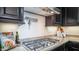 Gas cooktop and modern range hood in a stylish kitchen at 8537 E Leland St, Mesa, AZ 85207