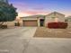 Single-story home with a two-car garage and landscaped front yard at 9438 W Georgia Ave, Glendale, AZ 85305