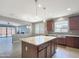 Open-concept kitchen with an island and views into the adjacent living area at 9438 W Georgia Ave, Glendale, AZ 85305