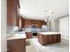 Modern kitchen with an island, dark wood cabinets, and gray tile backsplash at 9438 W Georgia Ave, Glendale, AZ 85305