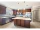 Spacious kitchen featuring an island, stainless steel appliances, and ample cabinetry at 9438 W Georgia Ave, Glendale, AZ 85305