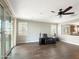 Living room with tile flooring, sliding glass doors, and a home theater setup at 9438 W Georgia Ave, Glendale, AZ 85305