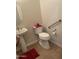 Clean bathroom with pedestal sink, toilet and grab bar at 10040 E Grandview St, Mesa, AZ 85207