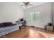 Bedroom with wood floors, window, ceiling fan and a daybed at 10040 E Grandview St, Mesa, AZ 85207