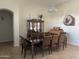 Formal dining room features a large table, hutch, and elegant chandelier at 10040 E Grandview St, Mesa, AZ 85207