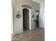 Bright entry hall with tile flooring and arched doorways leading to other rooms at 10040 E Grandview St, Mesa, AZ 85207