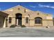 Tan colored house with decorative accents, arched entryway, and attached garage at 10040 E Grandview St, Mesa, AZ 85207