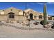 Beautiful desert landscape surrounds this single-story home with a large front yard at 10040 E Grandview St, Mesa, AZ 85207