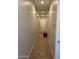 Long hallway with tile flooring and neutral walls, offering access to bedrooms at 10040 E Grandview St, Mesa, AZ 85207