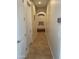 Long hallway with tile flooring and neutral walls, offering access to bedrooms at 10040 E Grandview St, Mesa, AZ 85207