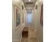 Spacious hallway with tile floors and artwork, leading to various rooms at 10040 E Grandview St, Mesa, AZ 85207