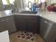 Modern kitchen with double sinks, stainless steel dishwasher, and white countertops at 10040 E Grandview St, Mesa, AZ 85207