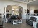 Bright and airy living room with a view into the kitchen and dining areas at 10040 E Grandview St, Mesa, AZ 85207