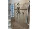 Walk-in shower with grab bars and tiled walls at 10040 E Grandview St, Mesa, AZ 85207