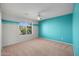 Bedroom with teal feature wall, carpet, and window at 1021 E Mead Dr, Chandler, AZ 85249