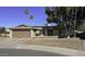 Single story home with brown brick exterior, two-car garage, and mature landscaping at 1320 W Palo Verde Dr, Chandler, AZ 85224