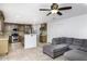 Open concept kitchen with island, gray sectional sofa, and view into living room at 1320 W Palo Verde Dr, Chandler, AZ 85224