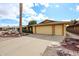 Home's exterior featuring a three-car garage, desert landscaping, and a concrete driveway at 13359 W Ballad Dr, Sun City West, AZ 85375