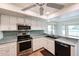 Modern kitchen featuring white cabinets, stainless steel appliances, and a tile backsplash at 13359 W Ballad Dr, Sun City West, AZ 85375