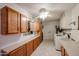 Functional laundry area features storage cabinets, tile floors, washer, dryer, and utility sink at 13359 W Ballad Dr, Sun City West, AZ 85375