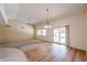 Bright living room with a ceiling fan, sliding glass doors, and large windows at 13359 W Ballad Dr, Sun City West, AZ 85375