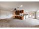 Open-concept living space with built-in cabinetry, a ceiling fan, and sliding glass doors to the outside at 13359 W Ballad Dr, Sun City West, AZ 85375