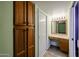 Bathroom vanity area features built in storage, recessed lighting, and adjacent bath at 13359 W Ballad Dr, Sun City West, AZ 85375