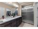 Spa-like bathroom with double vanity and walk-in shower at 16807 W Berkeley Rd, Goodyear, AZ 85395