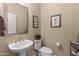 Clean bathroom with pedestal sink and toilet at 16807 W Berkeley Rd, Goodyear, AZ 85395