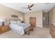 Spacious bedroom with carpeted floor and wood furniture at 16807 W Berkeley Rd, Goodyear, AZ 85395