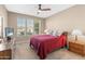 Bedroom with ceiling fan and red bedding at 16807 W Berkeley Rd, Goodyear, AZ 85395