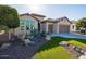 Single-story home with desert landscaping, two-car garage, and attractive facade at 16807 W Berkeley Rd, Goodyear, AZ 85395