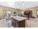 Open concept kitchen with island and breakfast bar, overlooking the Gathering room at 16807 W Berkeley Rd, Goodyear, AZ 85395