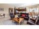 Relaxing living room with leather furniture and large TV at 16807 W Berkeley Rd, Goodyear, AZ 85395