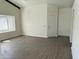 Bright living room with wood floors, lots of light from the window, and two entry doors at 1770 E Sandra Ter, Phoenix, AZ 85022
