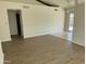 Open-concept living room featuring wood floors and access to a tiled kitchen and outdoor patio at 1770 E Sandra Ter, Phoenix, AZ 85022