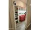 Organized storage room with red tool chest, shelving, peg board, and gray wood-look tile flooring at 17870 E Appaloosa Dr, Queen Creek, AZ 85142