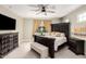 Main bedroom with large bed, dark dresser and ceiling fan at 20385 W Vista Paseo Dr, Buckeye, AZ 85396