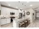 Modern kitchen with white cabinets, quartz countertops, and stainless steel appliances at 20385 W Vista Paseo Dr, Buckeye, AZ 85396