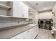 Functional laundry room with washer, dryer, cabinets, and countertop space at 20385 W Vista Paseo Dr, Buckeye, AZ 85396