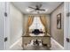 Home office with large desk, neutral color palette, and ceiling fan at 20385 W Vista Paseo Dr, Buckeye, AZ 85396