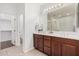 Double vanity bathroom with dark wood cabinets and tiled floors at 2133 E La Salle St, Phoenix, AZ 85040