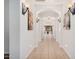 Elegant hallway with arched doorways and wall sconces, leading to various rooms at 2133 E La Salle St, Phoenix, AZ 85040