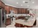 Island kitchen with granite countertops and dark wood cabinets at 2133 E La Salle St, Phoenix, AZ 85040