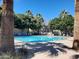 Sparkling community pool surrounded by lush landscaping and lounge chairs at 2133 E La Salle St, Phoenix, AZ 85040