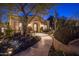 Beautiful desert landscaping surrounds this home at night at 26872 N 102Nd St, Scottsdale, AZ 85262