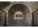 Elegant arched entryway leading to the three-car garage at 26872 N 102Nd St, Scottsdale, AZ 85262