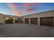 Three-car garage with wooden doors and brick archway at 26872 N 102Nd St, Scottsdale, AZ 85262